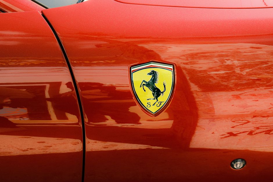 Detailed view of a sleek red sports car with an eye-catching emblem.